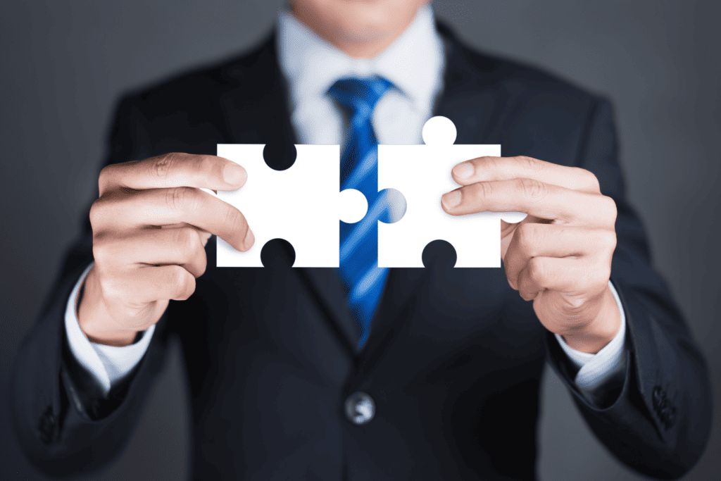 Bild mit Puzzle Stücken als Symbol für Unternehmensmakler und M&A Berater